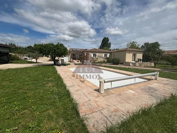 Maison de plain pied sur un terrain arboré et cloturé