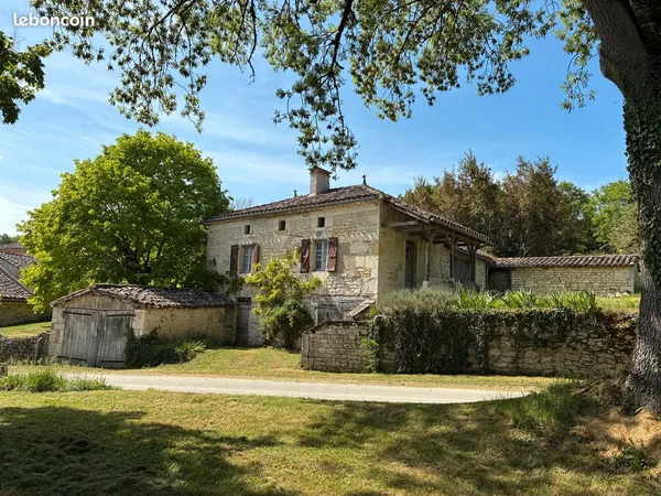 Groupe de maisons en pierre a renover avec hangars agricoles