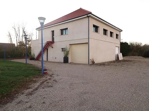 Grand bâtiment disposant de 3 grands garages et de 2 apparte