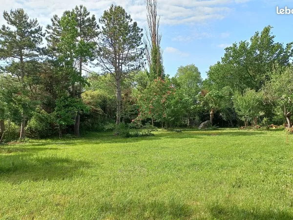 Terrain à bâtir plat et arboré de 1230 m² situé hors lotissement à proximité immédiate de Toulouse e