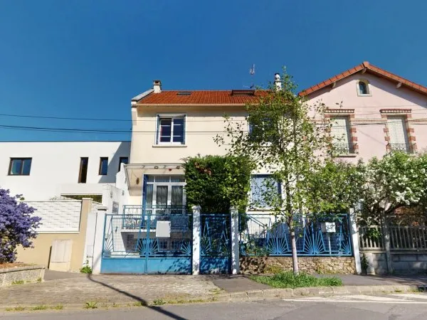 Charmante maison traversante avec véranda et jardin paysagé
